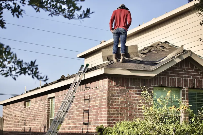 Professional roofer working on a residential roof in Overview
